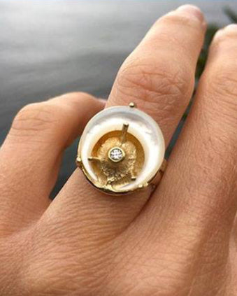 Gold ring with a diamond on a white background, worn on a hand, with 'March Bridal Madness' text and 'Natalie Michaels Skullpress' branding.