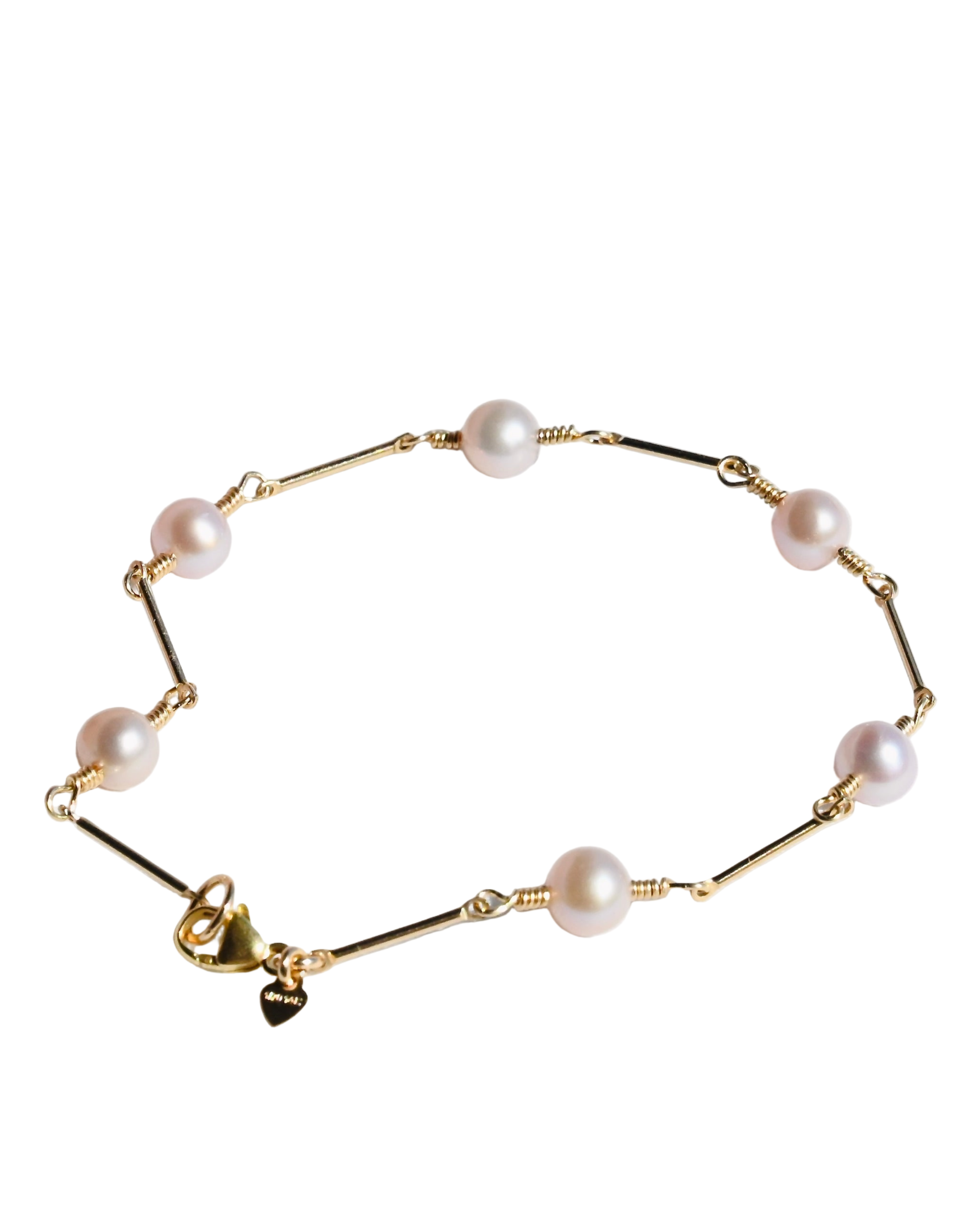 Gold bracelet with pearls on a white background
