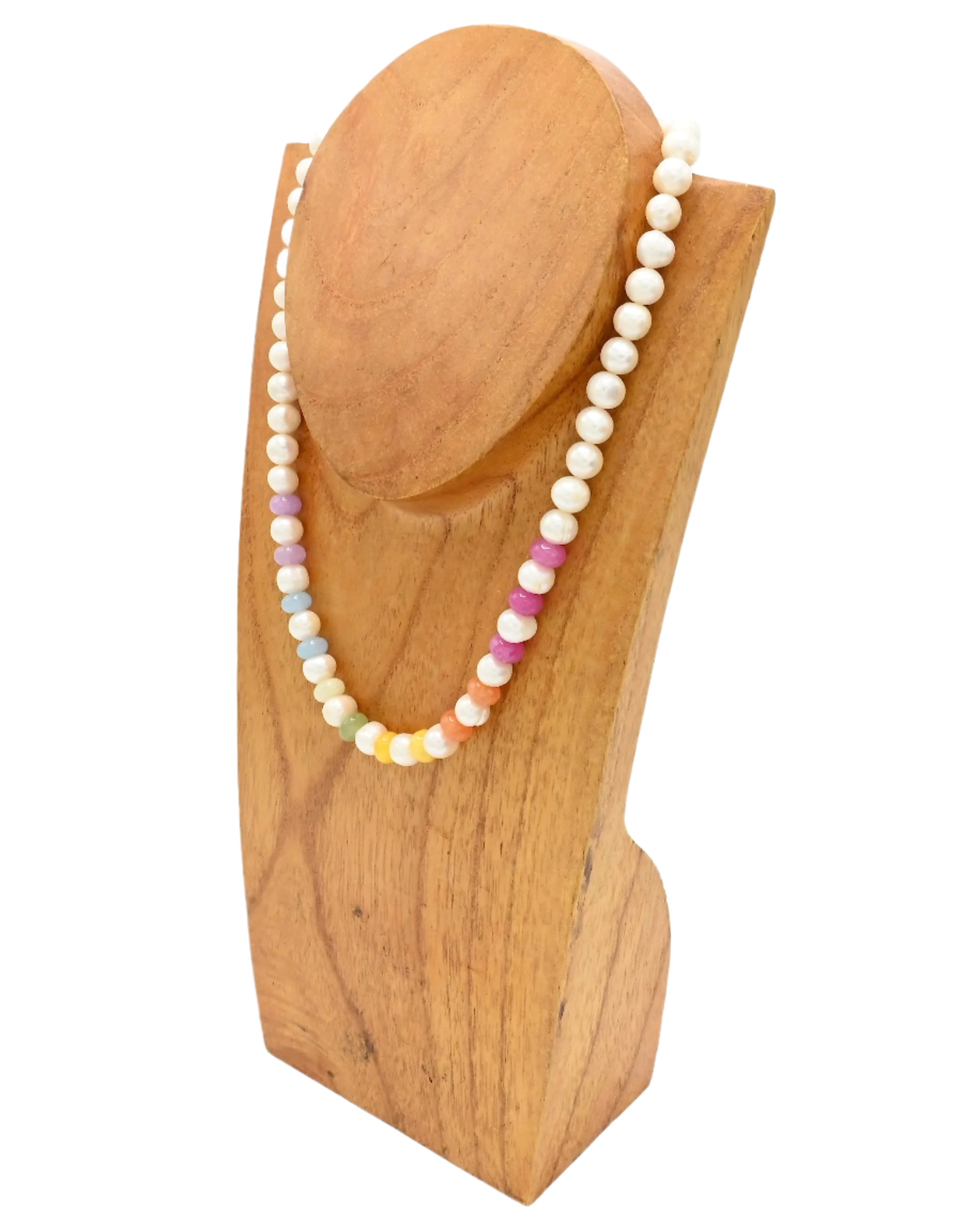 Necklace with multicolored beads on a wooden stand against a white background