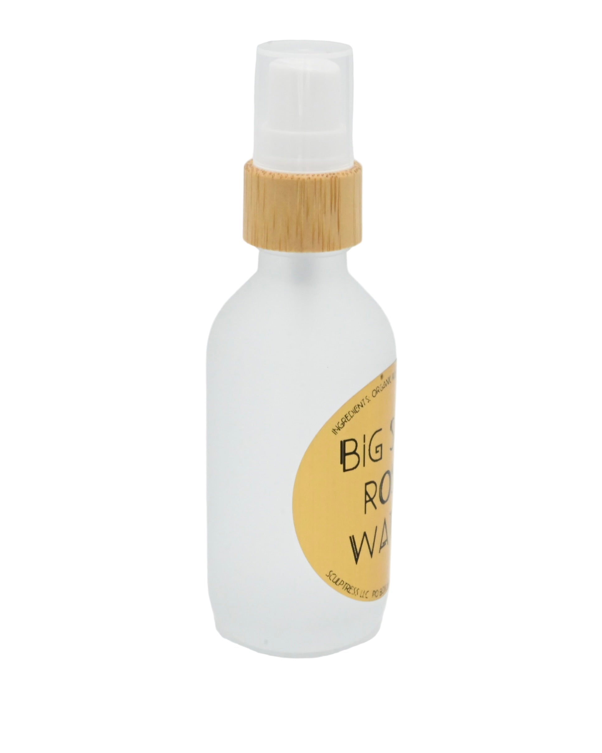 White bottle with a bamboo cap and yellow label on a white background