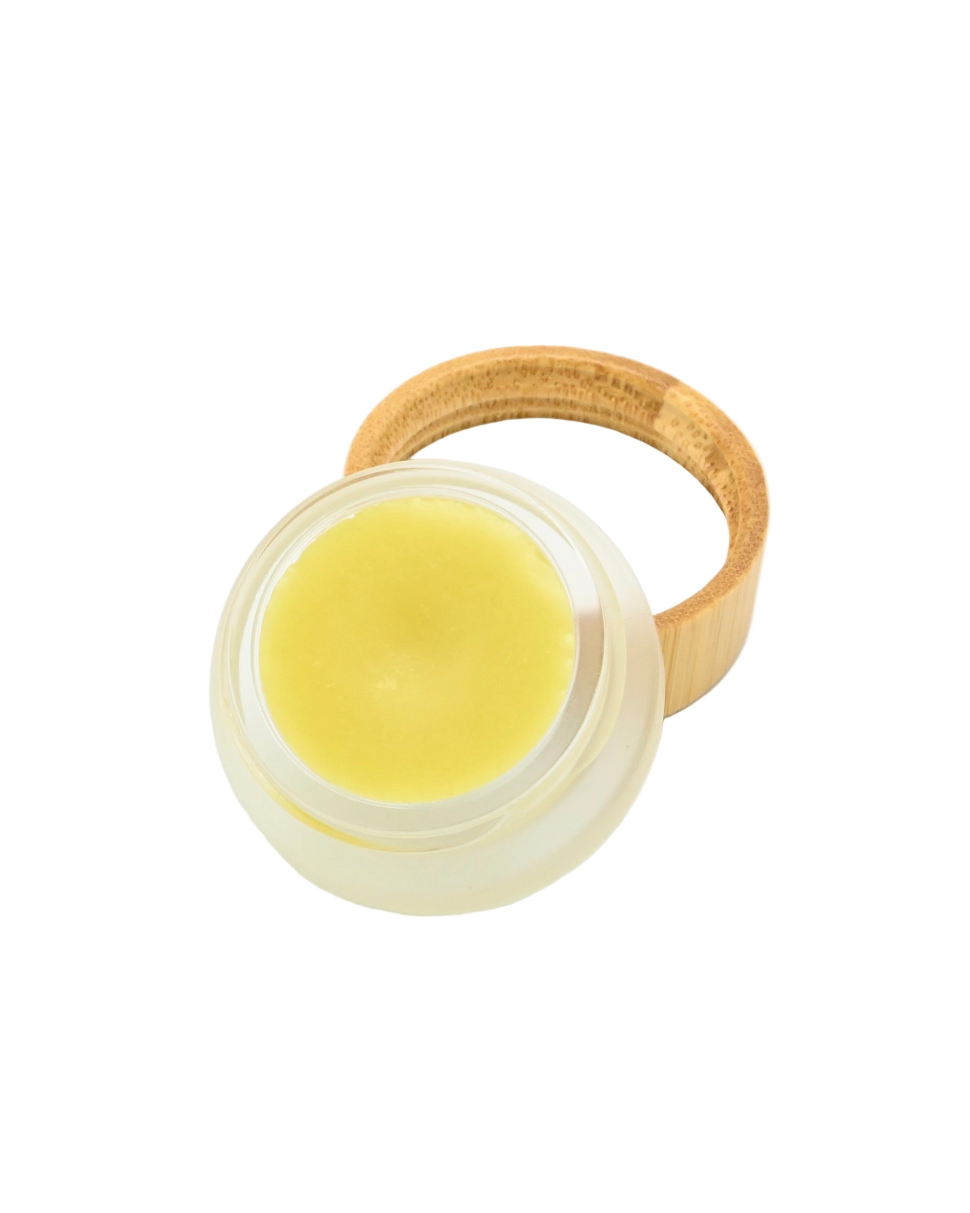 Balm in a glass container with a wooden lid on a white background