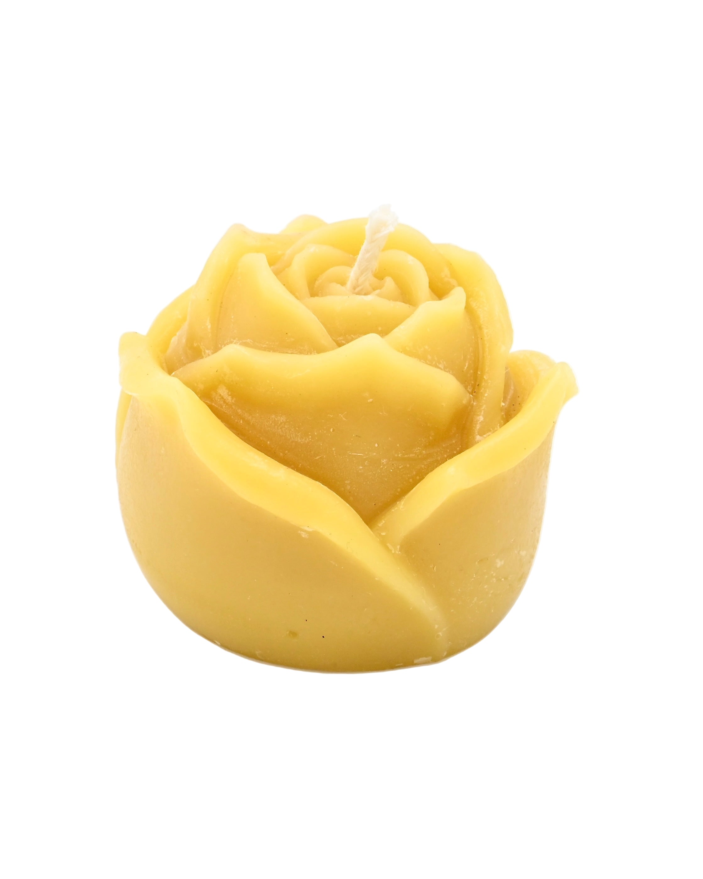 Yellow rose-shaped candle on a white background