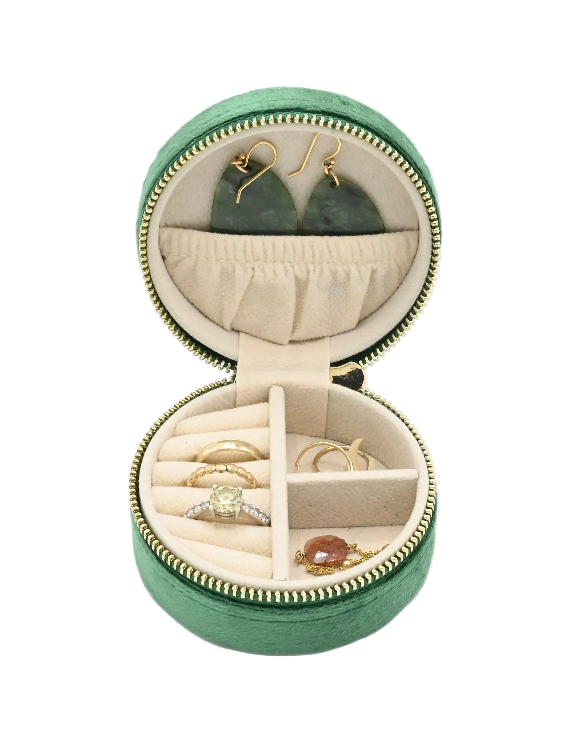 Green jewelry box with jewelry inside on a white background