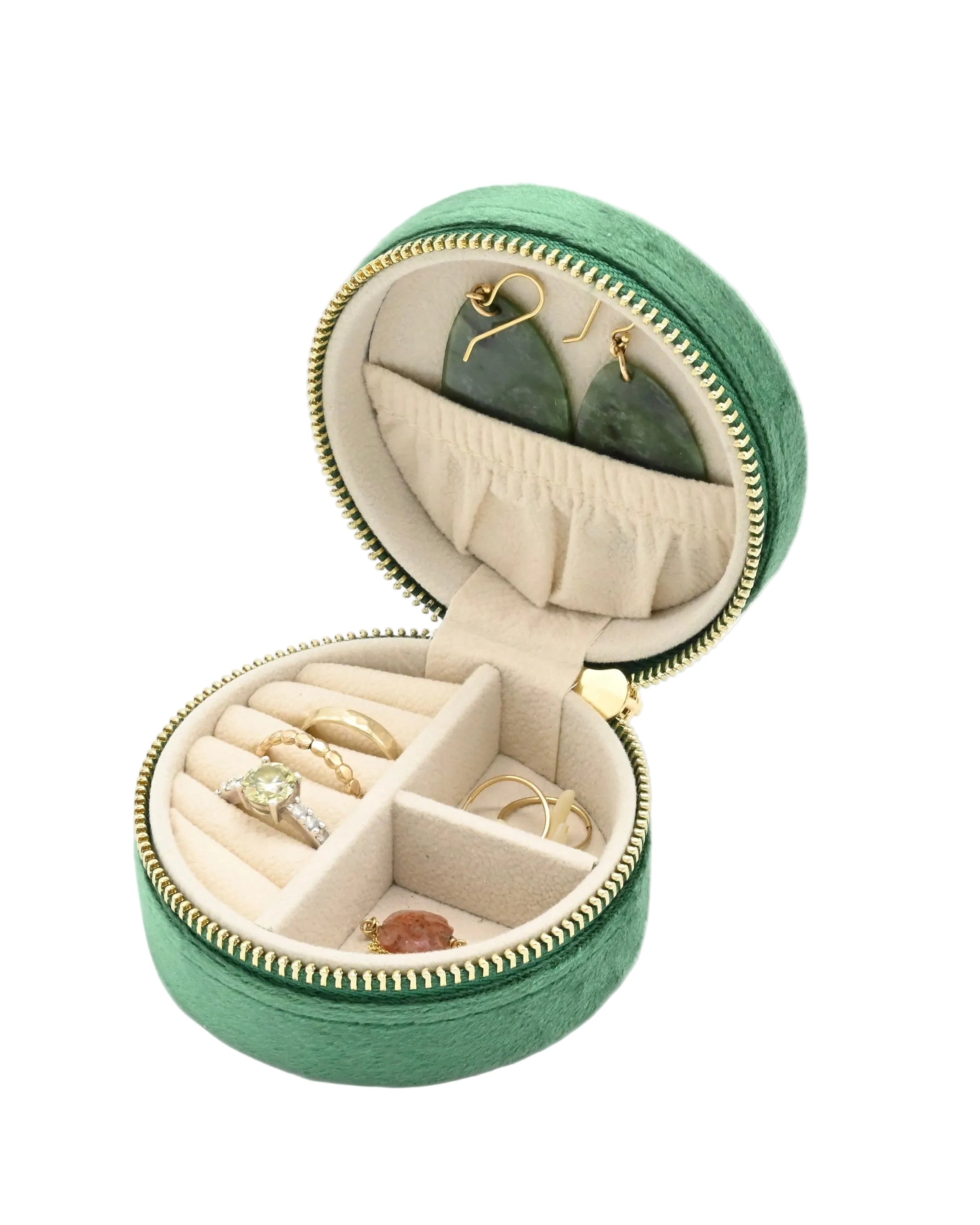 Green jewelry box with jewelry inside on a white background