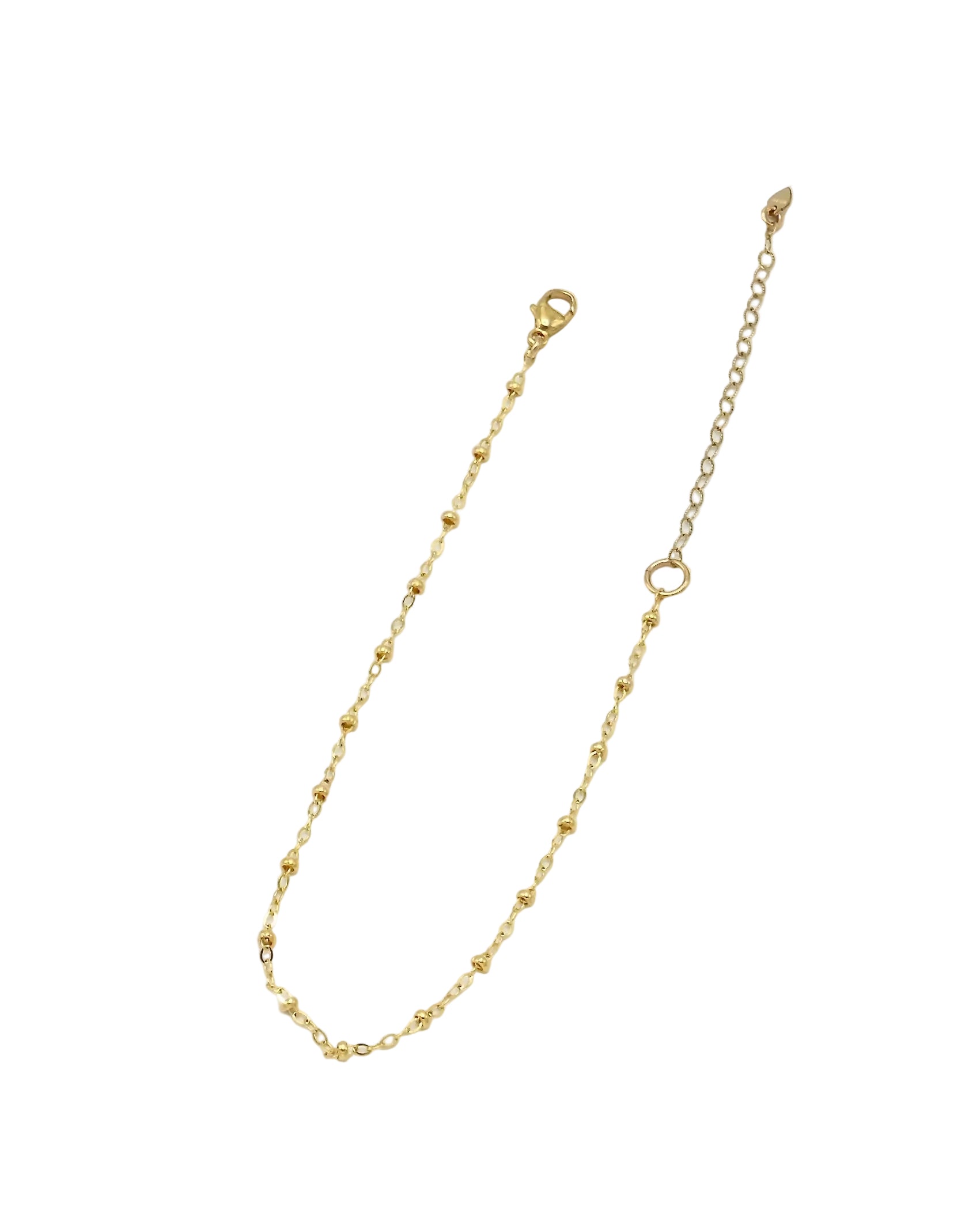 A delicate gold chain anklet with small bead-like links, a lobster clasp, and an adjustable extender chain with a ring, shown on a plain white background.