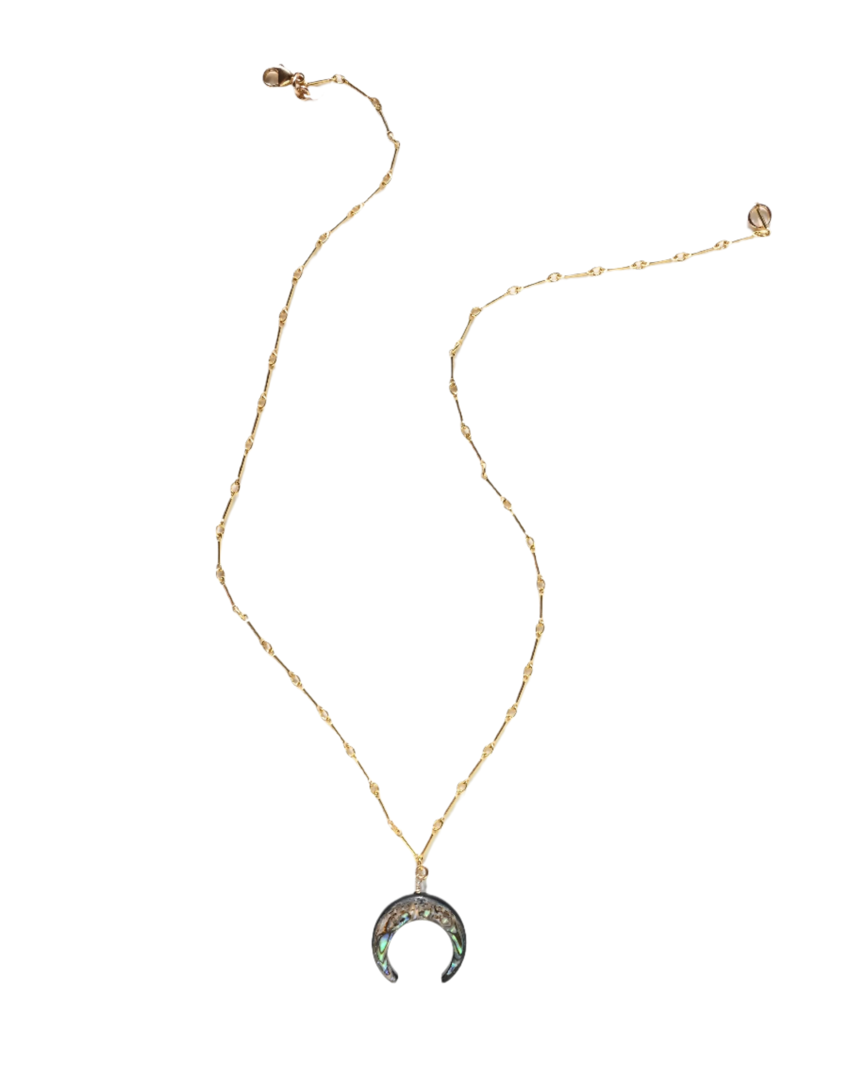 Gold necklace with a crescent moon pendant on a white background