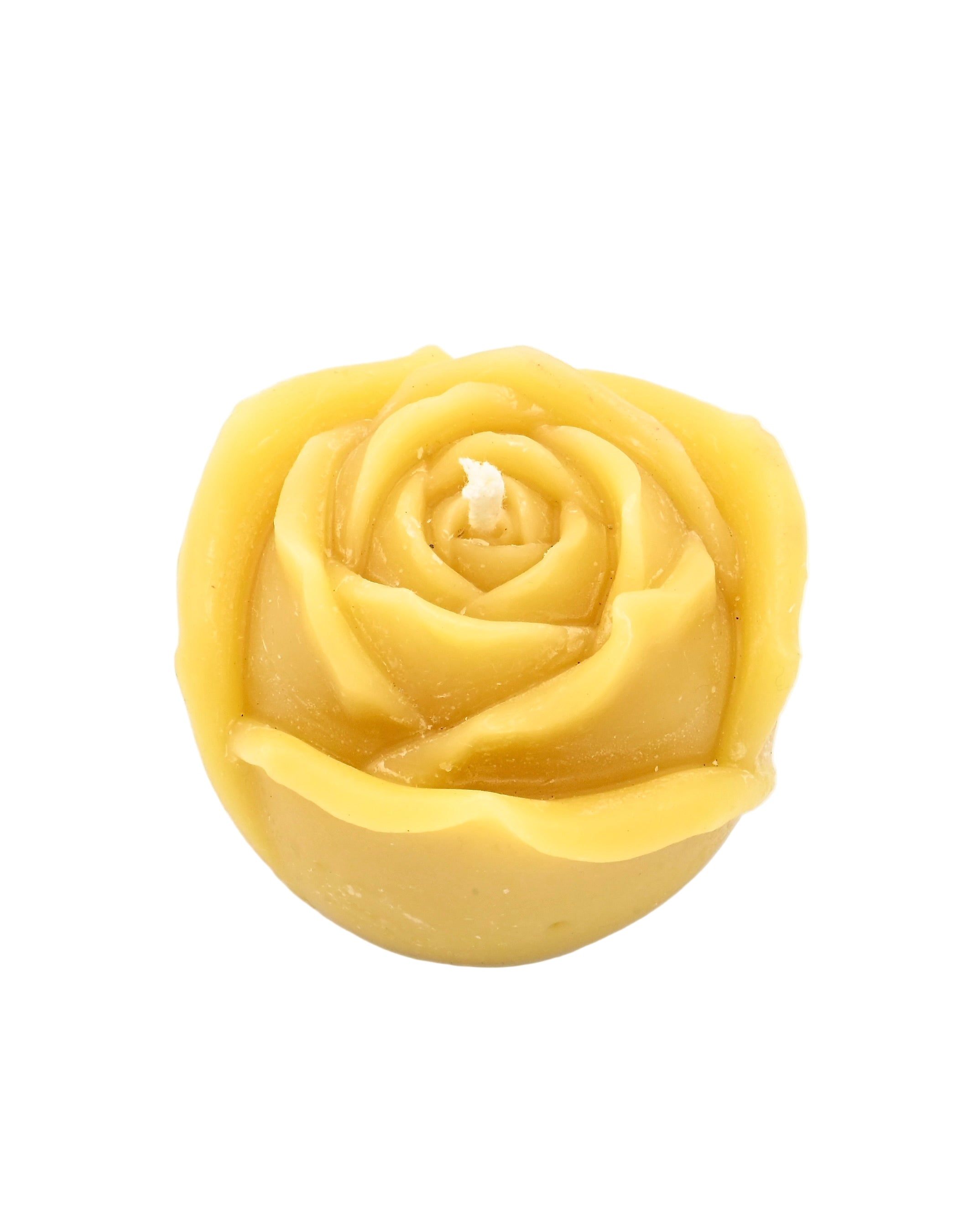 Yellow rose-shaped candle on a white background