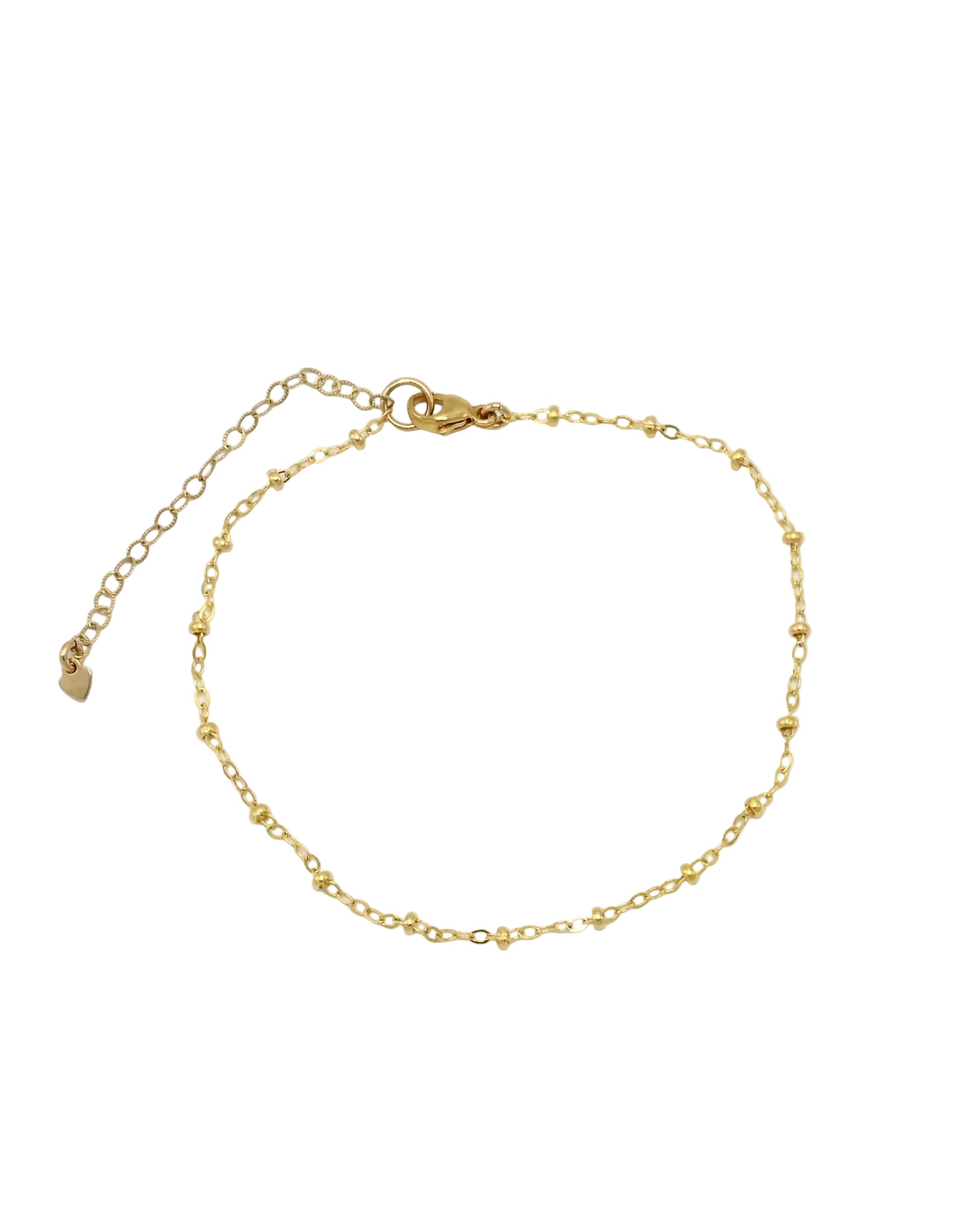 A delicate gold chain anklet with a lobster clasp, extender chain, and small heart-shaped charm, displayed on a clean white background.