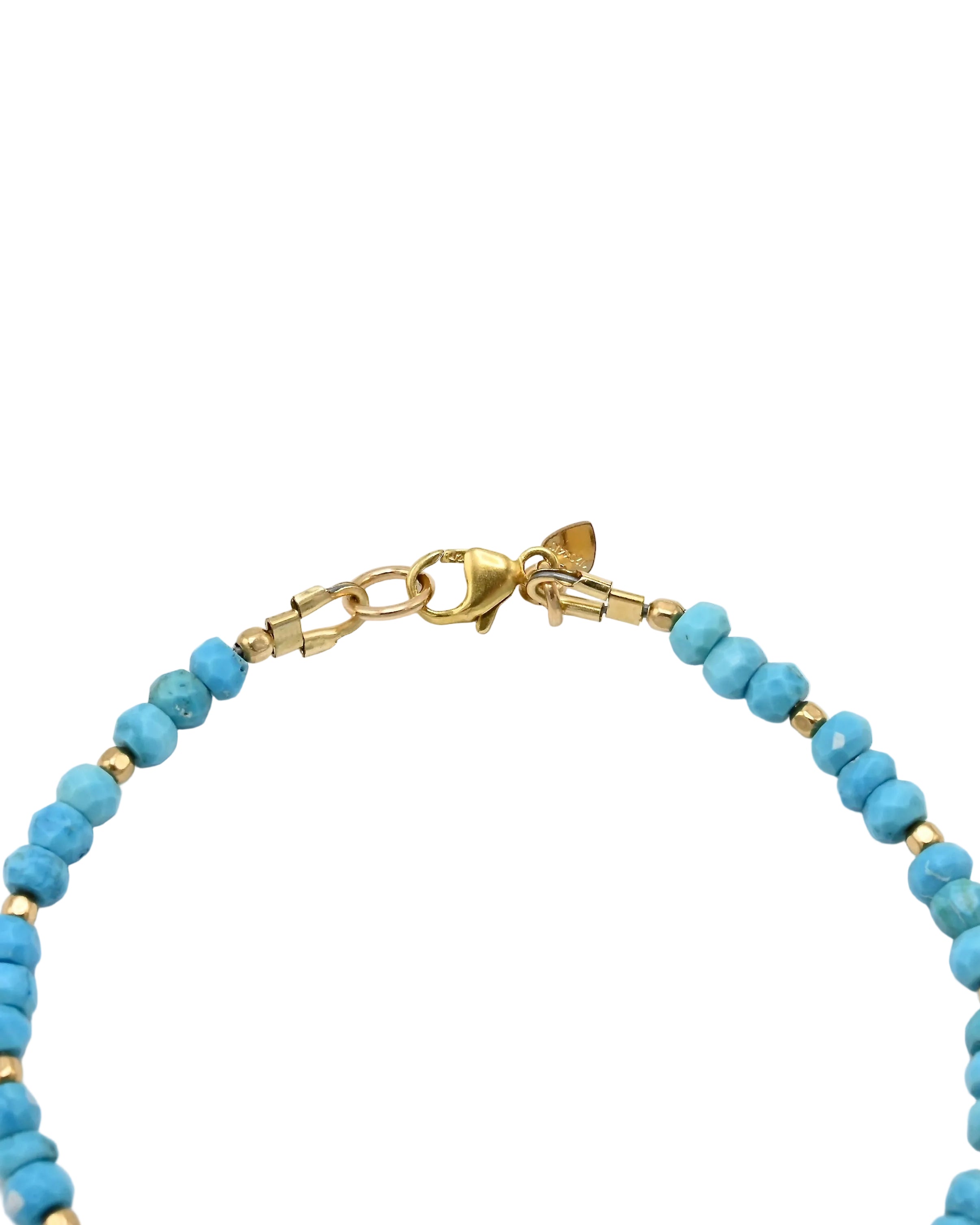 A close-up of a beaded bracelet featuring light blue turquoise round beads separated by small gold spacer beads, with a gold lobster clasp closure, shown on a plain white background.