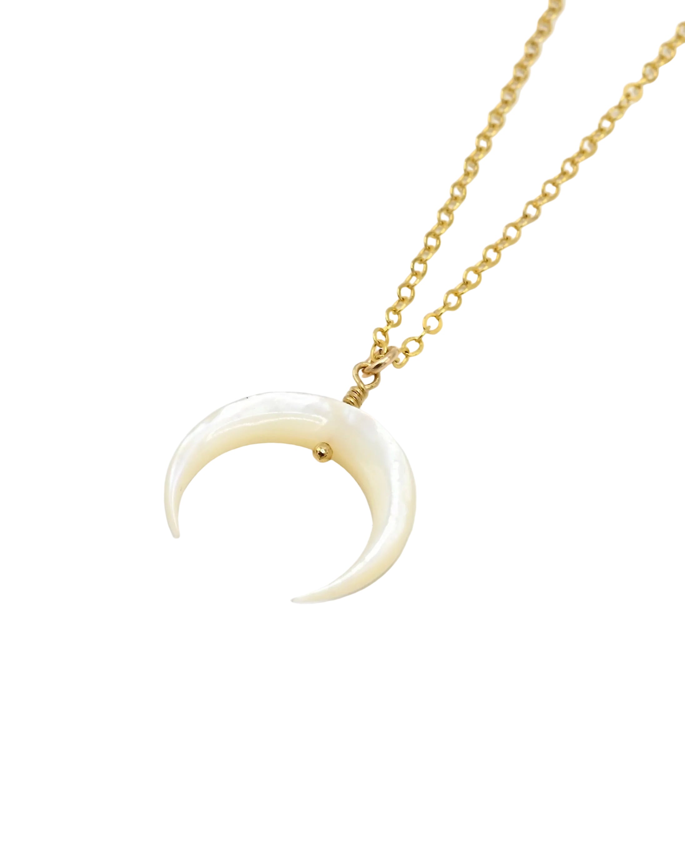 A gold chain necklace featuring a crescent moon pendant made of smooth, off-white bone or horn, photographed on a clean white background.