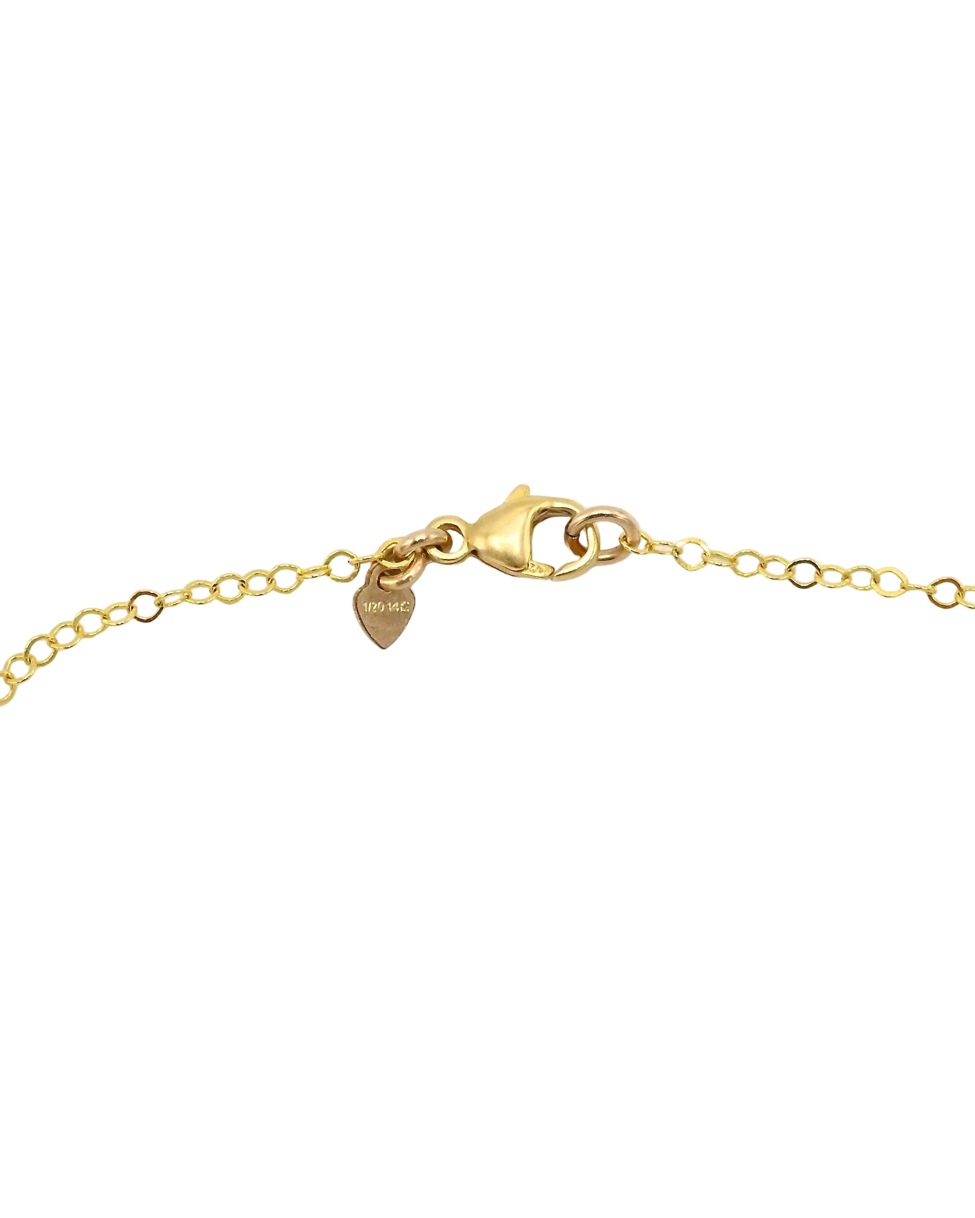 Close-up of a gold chain bracelet showing a lobster clasp, extender links, and a small heart-shaped tag on a plain white background.