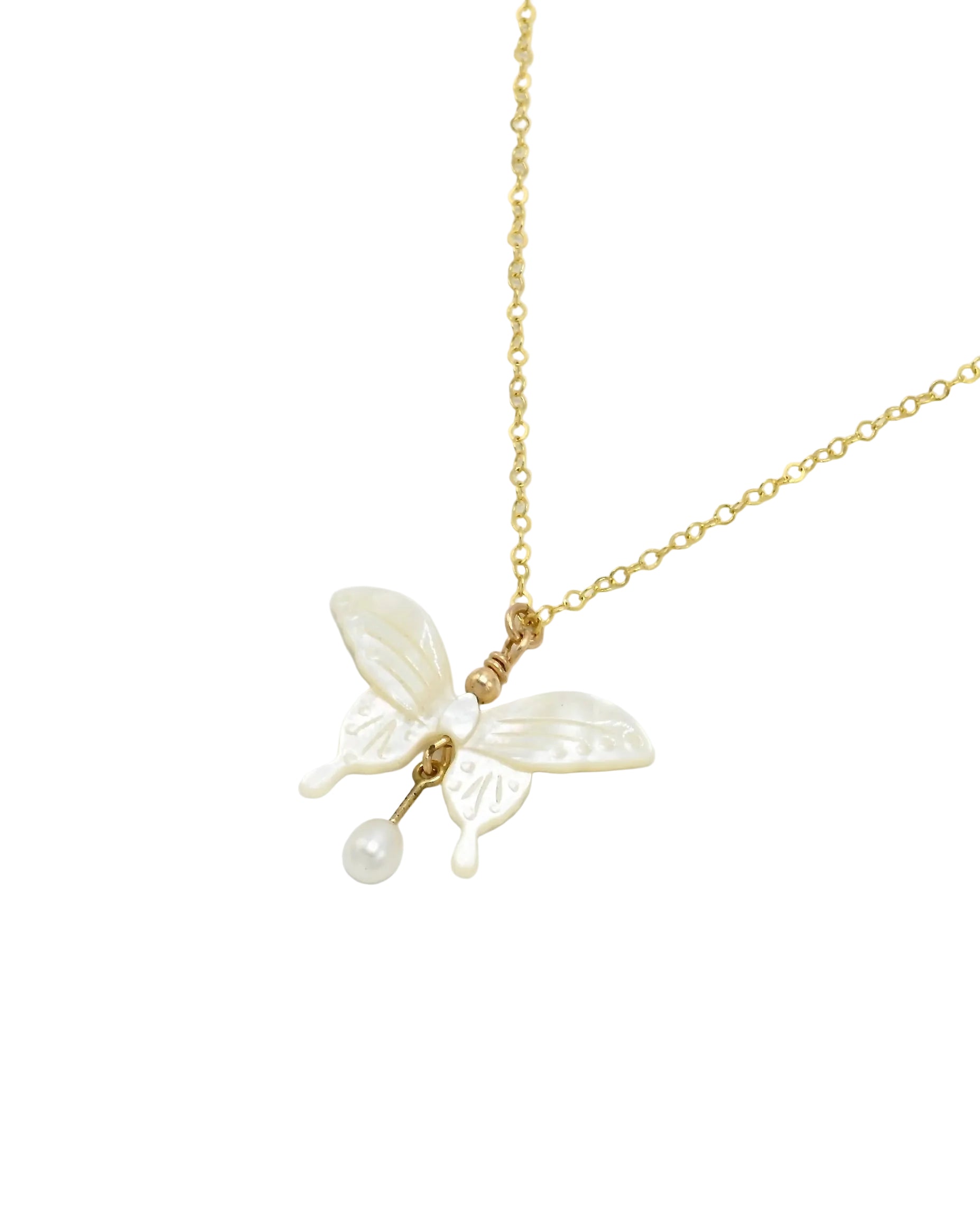 A delicate gold chain necklace featuring a butterfly pendant crafted from white mother-of-pearl, with a small pearl drop hanging from the center, shown against a plain light gray background.