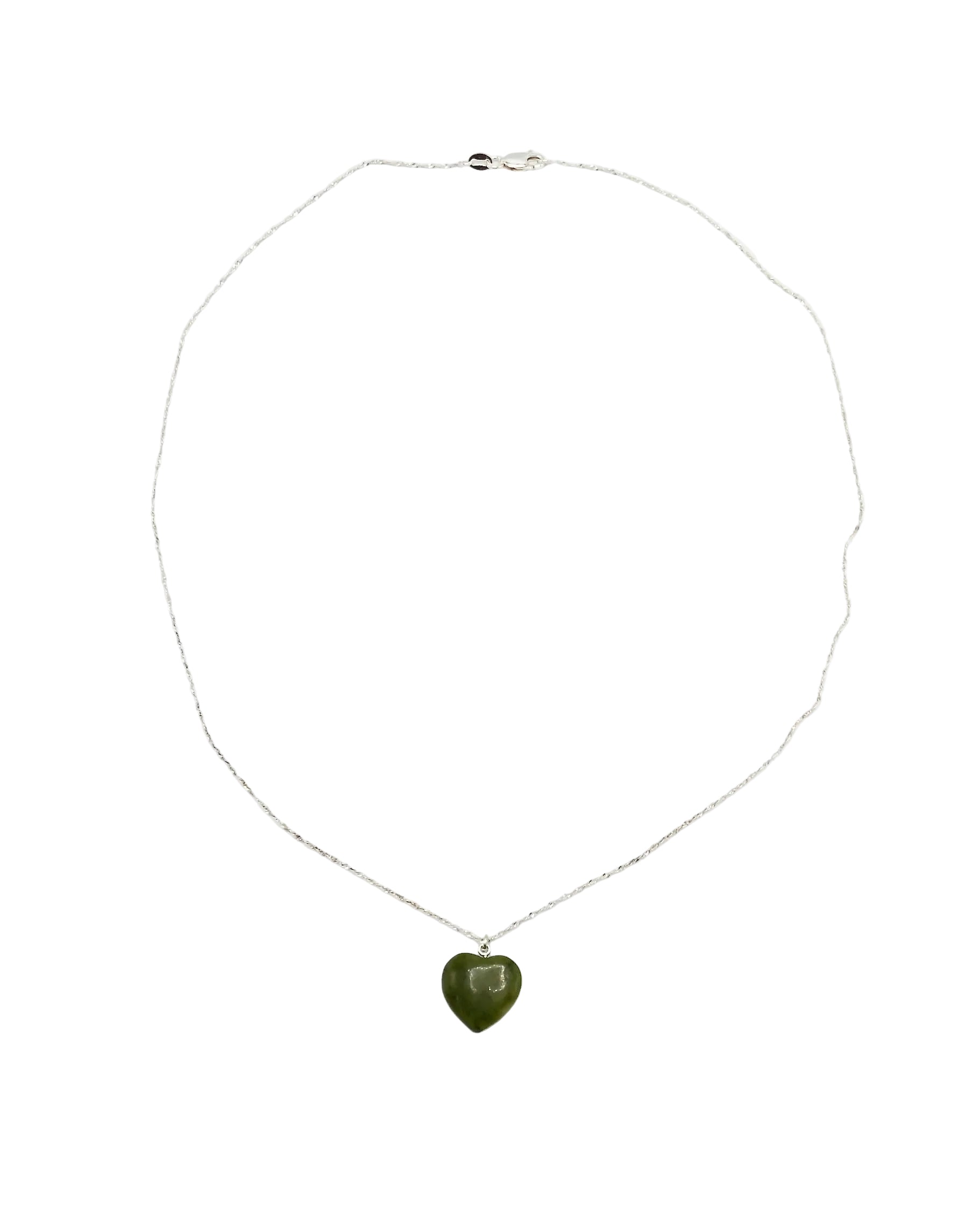 A delicate silver chain necklace featuring a small, polished green heart-shaped pendant, displayed against a plain white background.