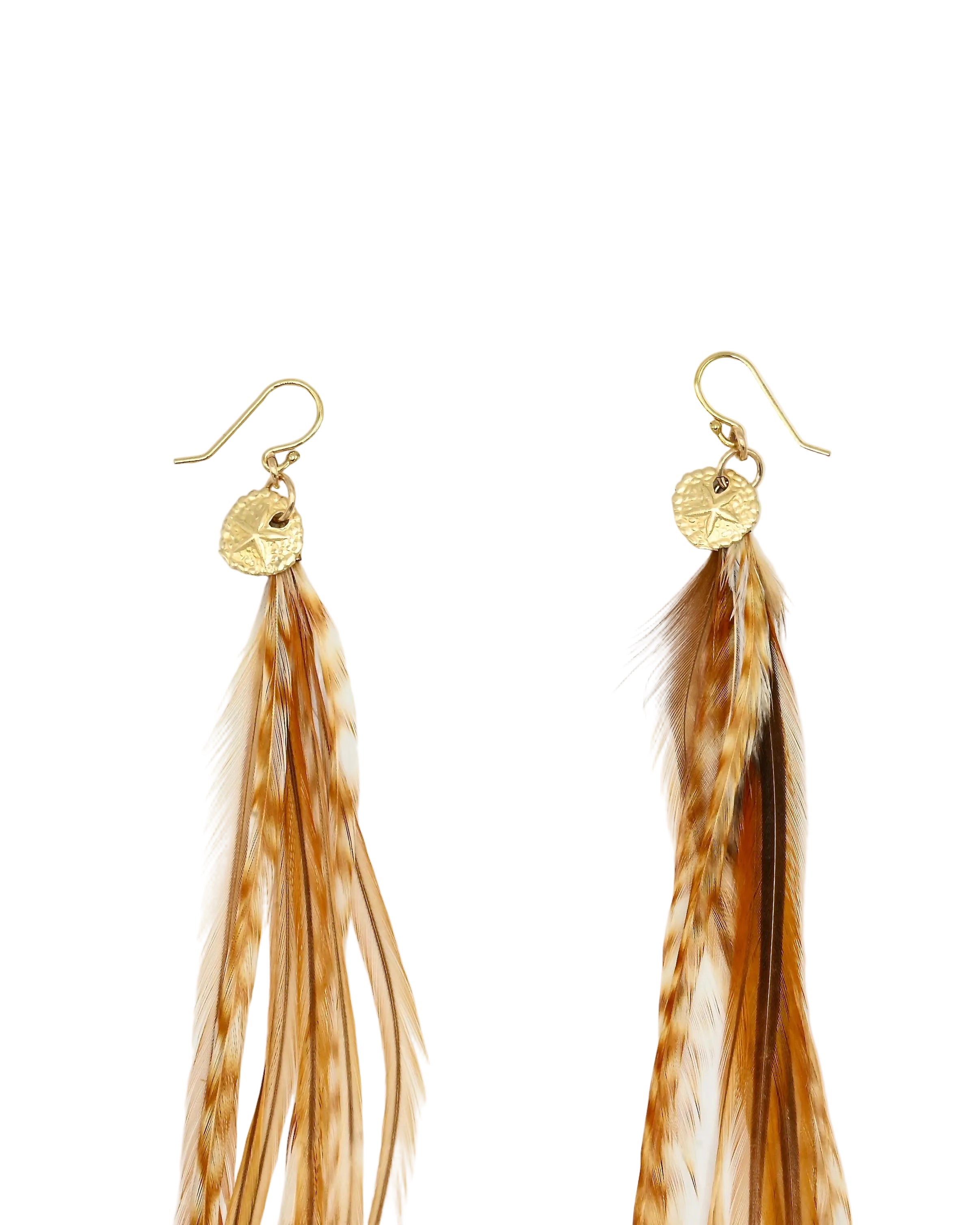 A pair of long dangling earrings with gold fishhook wires, small textured gold discs, and natural light brown and tan feathers hanging below, shown on a plain white background.