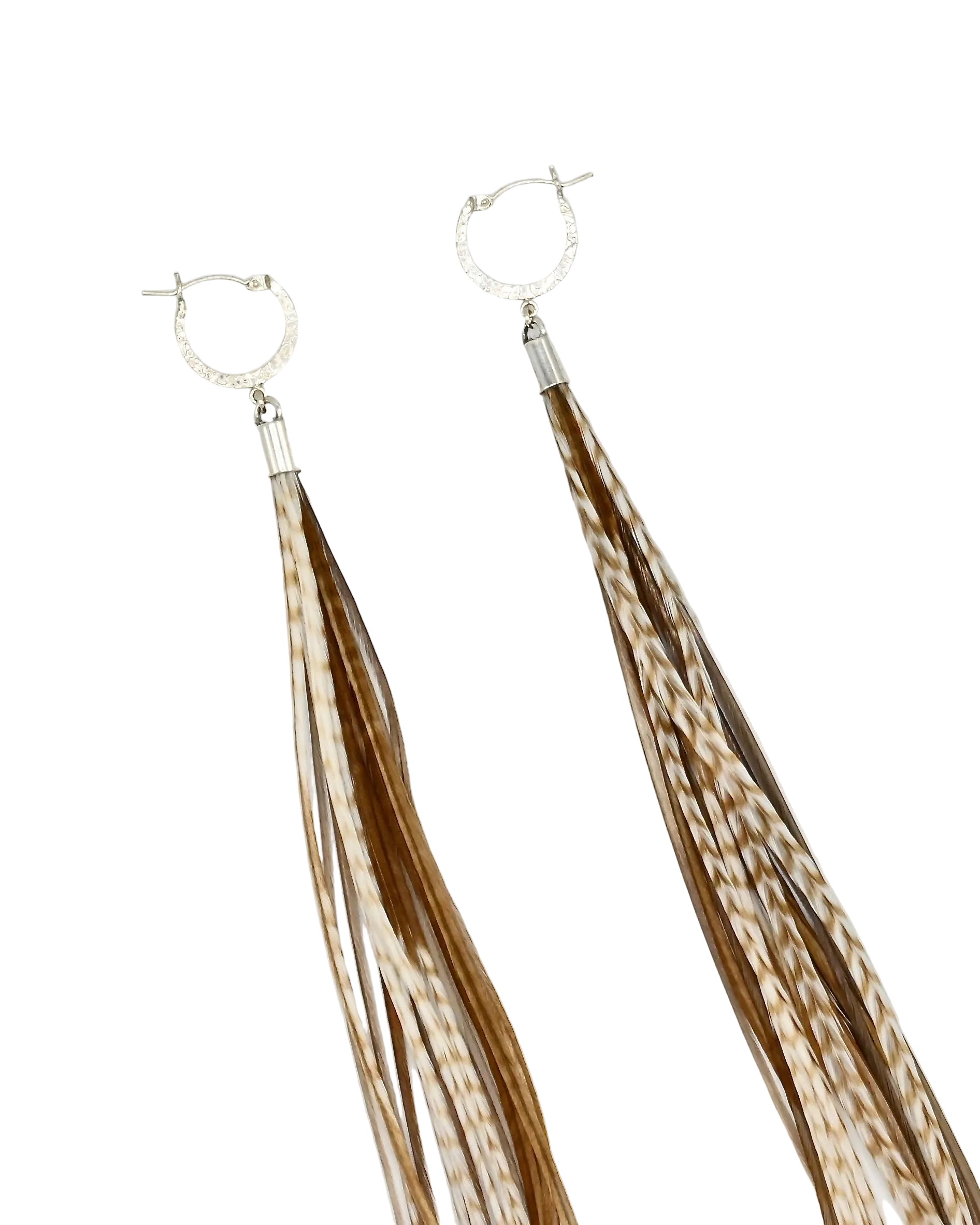 A pair of long dangle earrings with textured silver hoop tops and multiple thin fringe strands in brown and cream, photographed on a plain white background.
