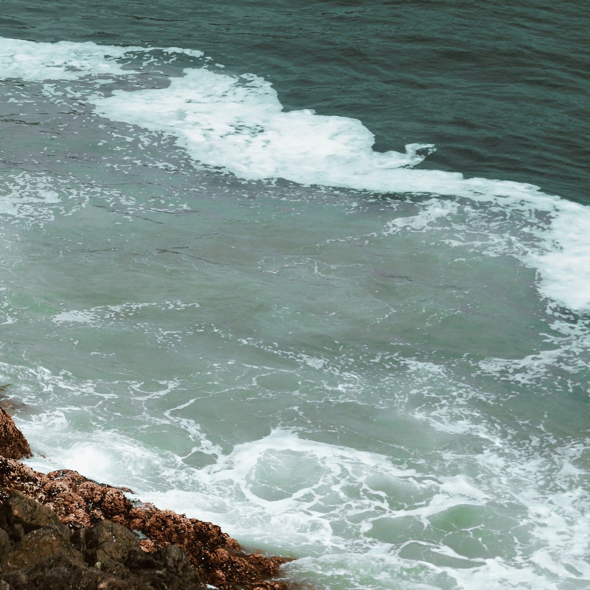 Water element jewelry — aerial deep-teal ocean foam over rocks, handmade in Big Sur | Sculptress